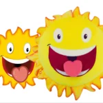 Urgo, the sun character of Vistalife vitamins, as illustration next to the custom plush toy made by Progimpex, with the same open smile, tongue and eyes.